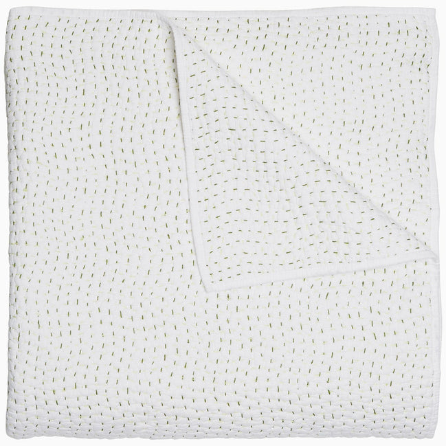 A John Robshaw Organic Hand Stitched Moss Quilt with hand stitched, gold dots on it.