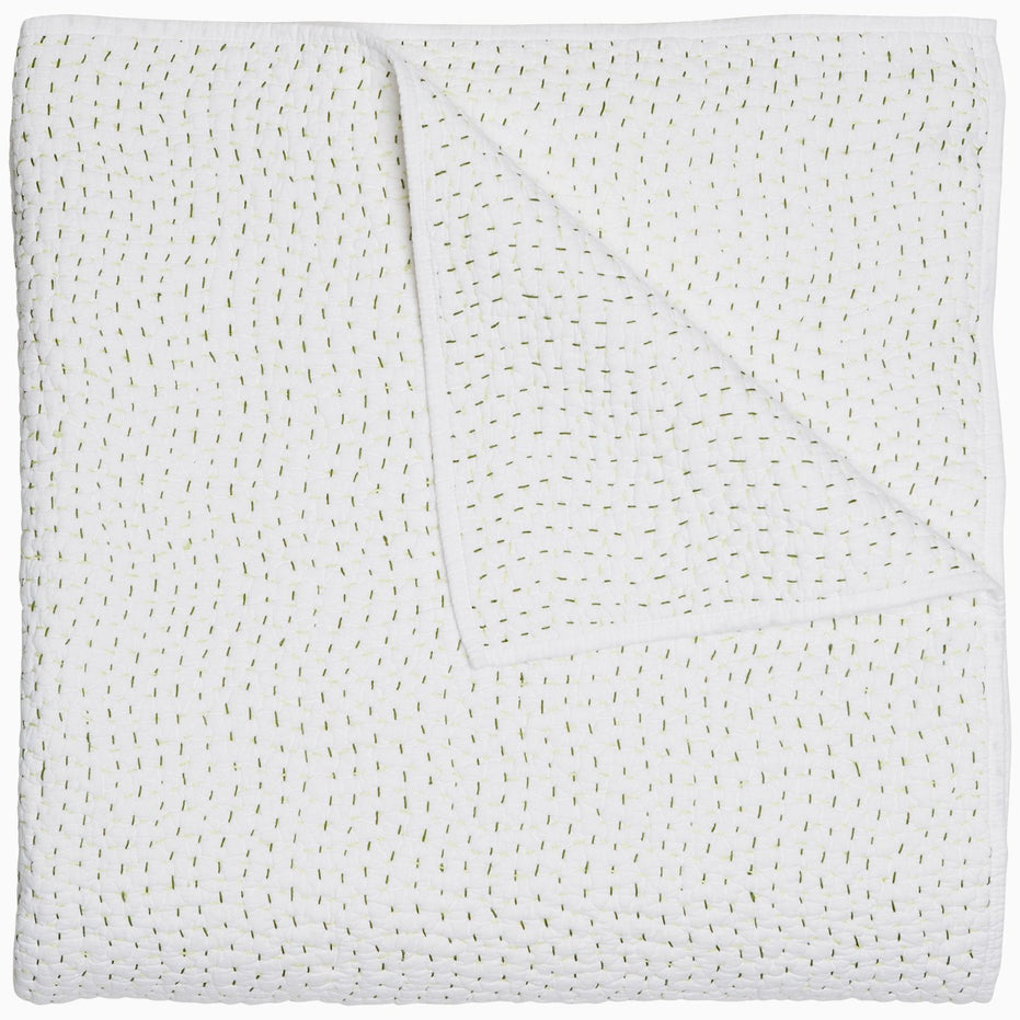A John Robshaw Organic Hand Stitched Moss Quilt with hand stitched, gold dots on it.