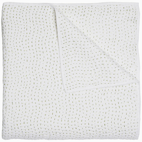 A John Robshaw Organic Hand Stitched Moss Quilt with hand stitched, gold dots on it.