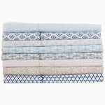 A stack of blue and white John Robshaw Kama Light Indigo Organic Sheet Sets, made with organic cotton, suitable for machine wash. - 28202300145710