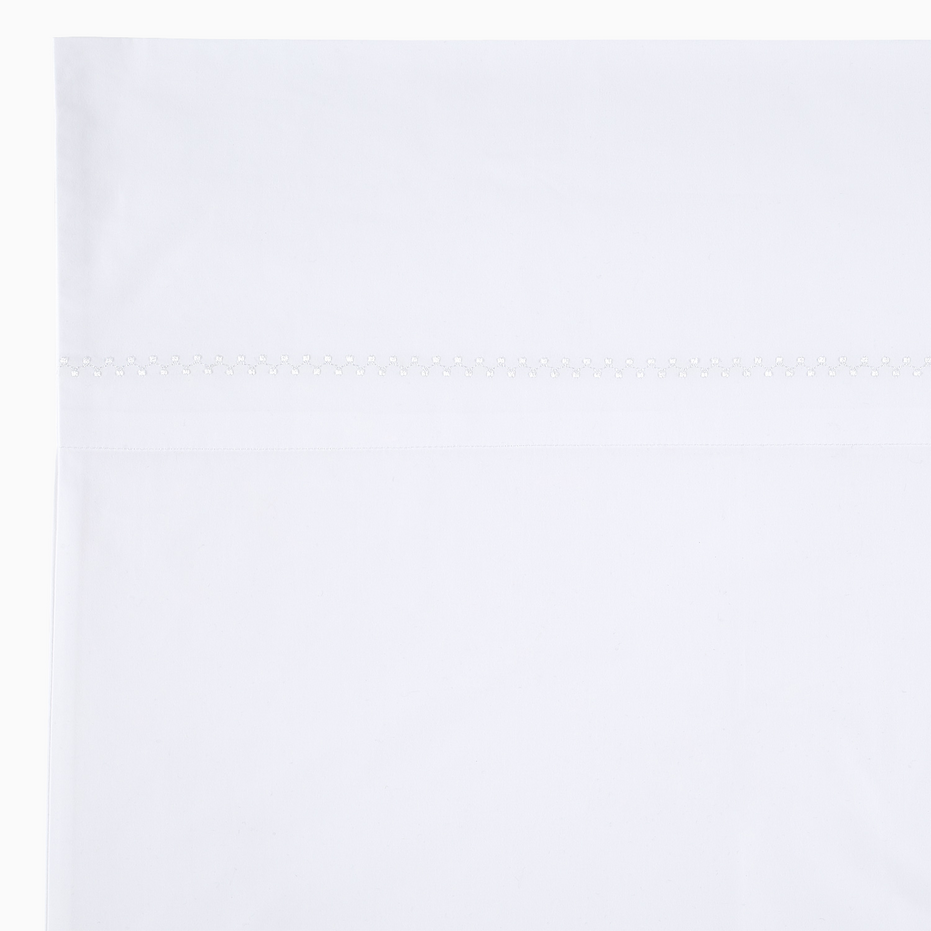 An Anketi White Organic Sheet Set with a white border on it, made from organic cotton percale with long-staple fibers, by John Robshaw.