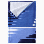 A John Robshaw Malda Indigo Beach Towel handwoven in Uzbekistan. - 29274359463982