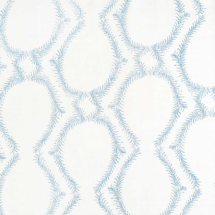 A blue and white pattern inspired by traditional craftsmanship creates a stunning design, using the Aerial Light Indigo Fabric by John Robshaw.