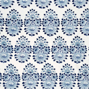 A blue and white floral pattern, created through traditional craftsmanship using Lanka Lapis Fabric by John Robshaw.