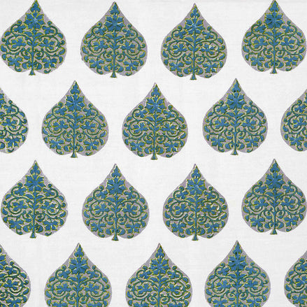A hand block printed Ratana Peacock fabric in blue and green leaf pattern on a white linen/cotton blend fabric, showcasing traditional craftsmanship by John Robshaw.