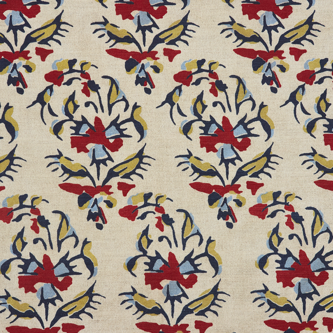 A Vijani Teak Fabric by John Robshaw, hand block printed with traditional craftsmanship, featuring beige color and vibrant designs in red, blue, and yellow.